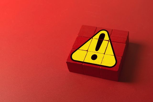 赤い背景にある黄色い注意マーク