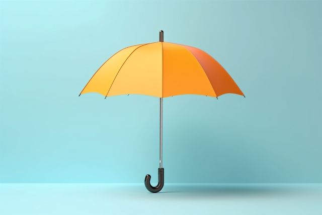 青の背景の前に置いてある黄色い傘