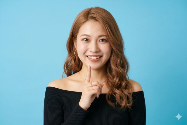 人差し指を立てている女性