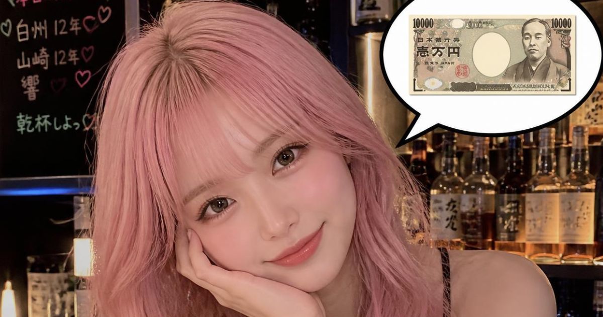 若い淡いピンク色の髪の色のウェーブロングヘアのかわいい女性が頬付えをついている