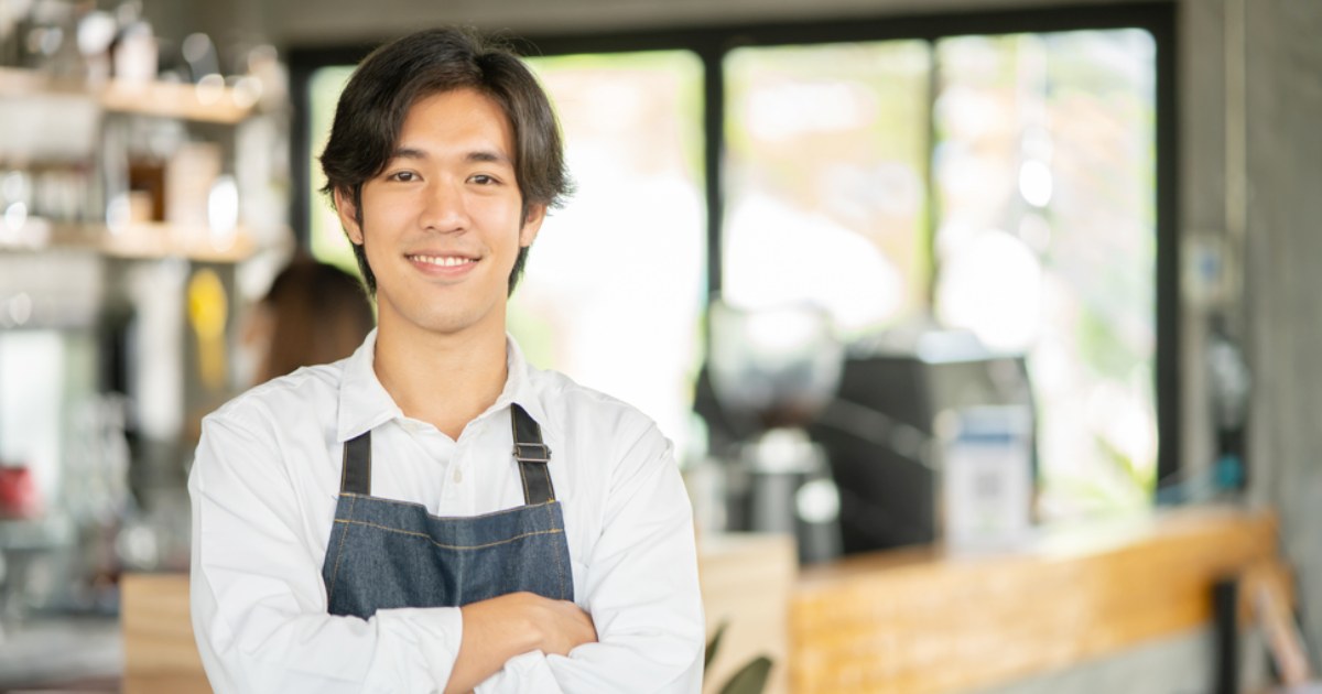 腕を組む料理人の若い男性