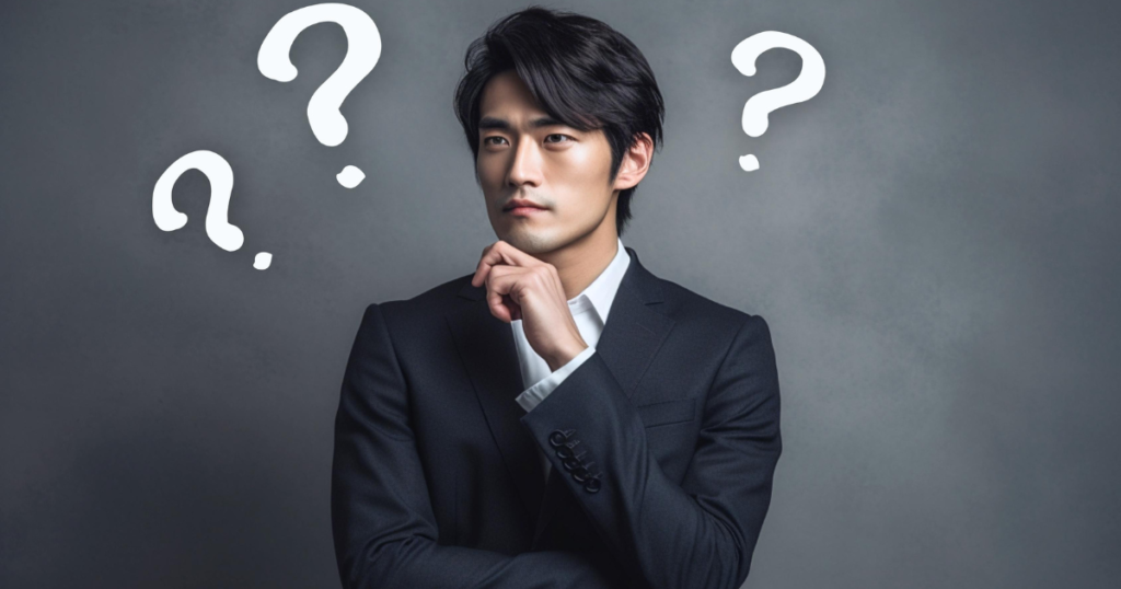 クエスチョンマークと考え事をする男性