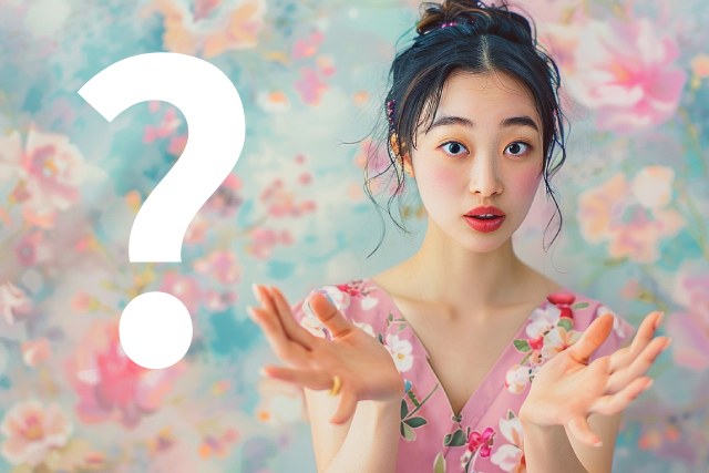 花柄のワンピースを着る日本人の女性とクエスチョンマーク