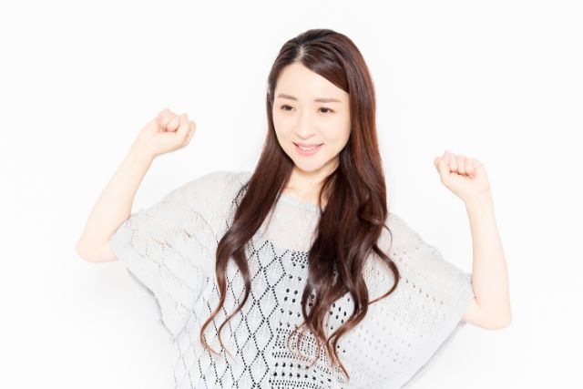 両腕を上げ喜んでいる女性