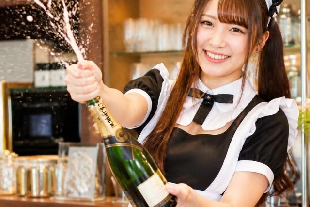 嬉しそうにシャンパンを開けるメイド嬢